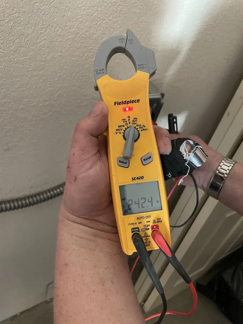 Voltage testing with clamp meter during Outlet Installation in Palm River-Clair Mel
